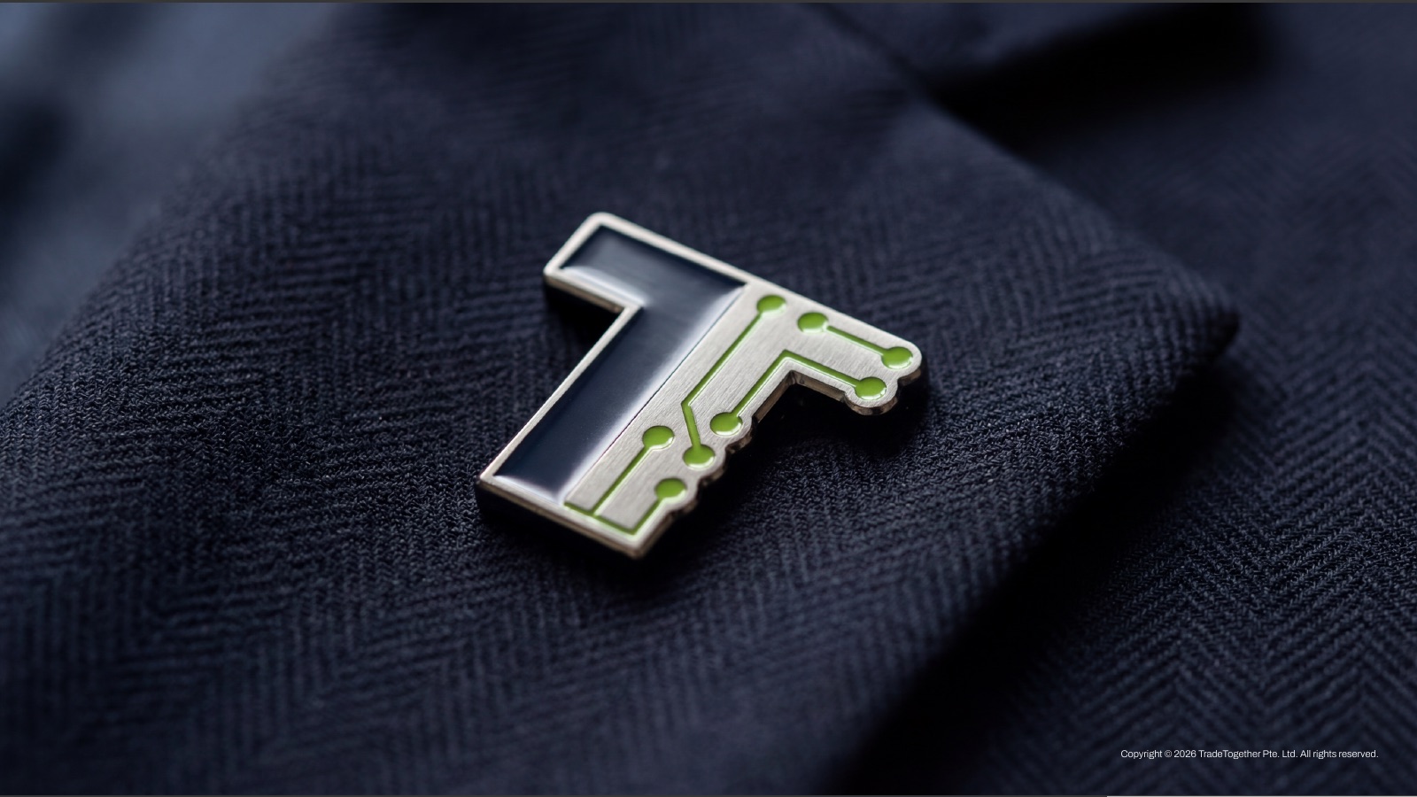 Enamel lapel pin of the TradeTogether symbol on a navy jacket